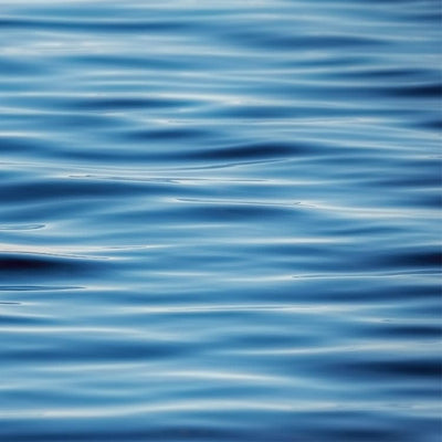 scrapbook paper featuring a photographic close up image of gentle blue waves