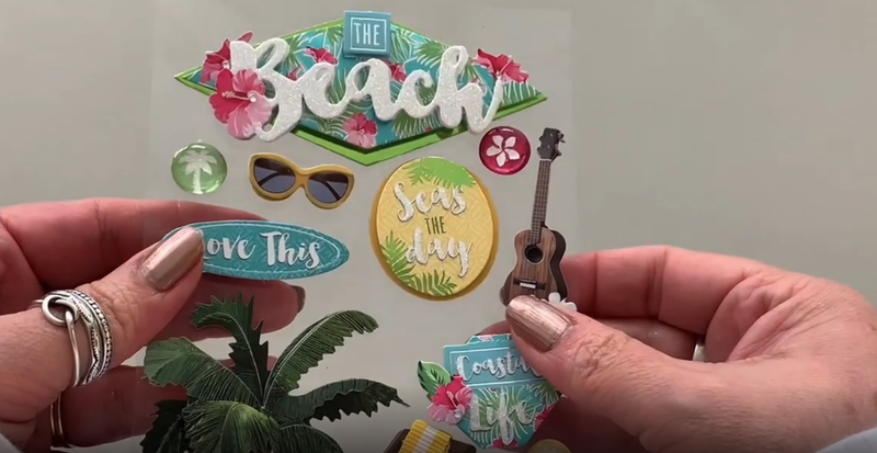 Female hands pick up and show front and back of 3D scrapbook stickers featuring photo real beach chair, flip flops and palm tree.