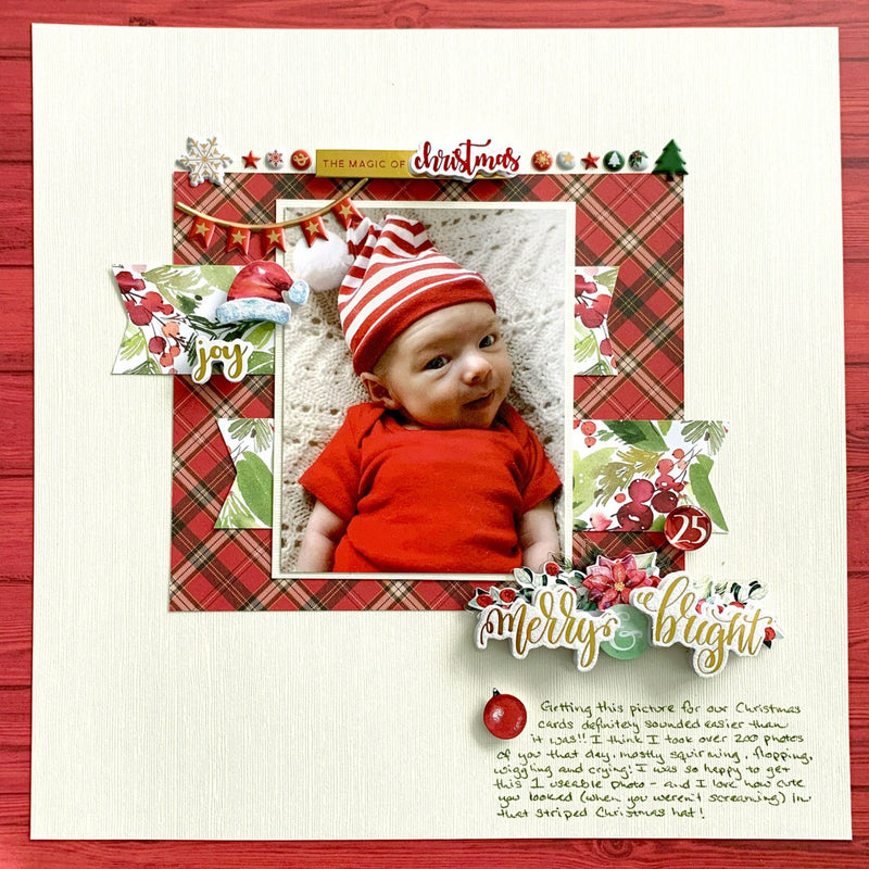 Christmas scrapbook page of infant dressed in a red onsie and red and white striped Santa hat