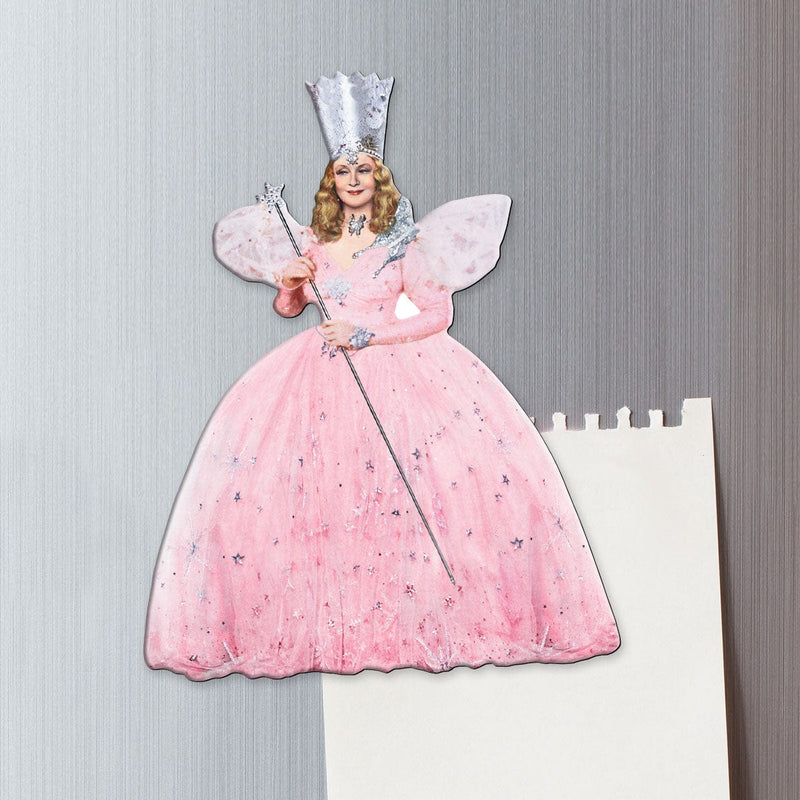 fridge magnet featuring Glinda, the good witch shown on a metal background attached to a torn sheet of memo paper.