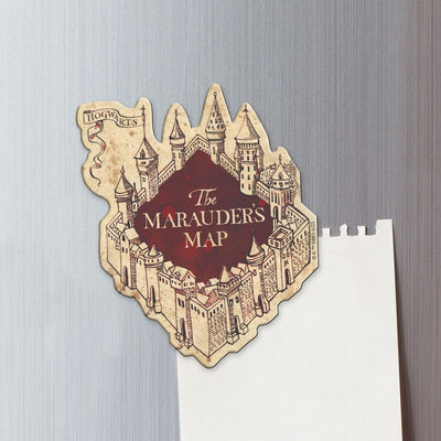 fridge magnet featuring a shaped marauder's map drawing shown on a metal background attached to a torn sheet of white memo paper.
