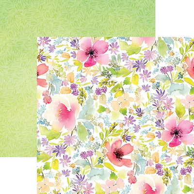 This scrapbook paper features pink, purple and green watercolor florals on one side, overlapping a green leaf pattern.