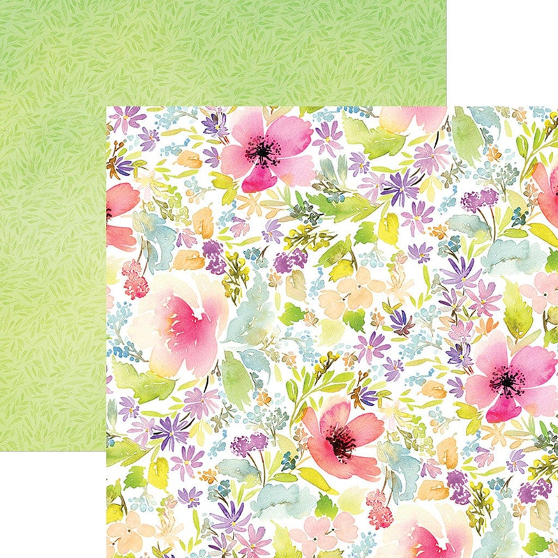 This scrapbook paper features pink, purple and green watercolor florals on one side, overlapping a green leaf pattern.