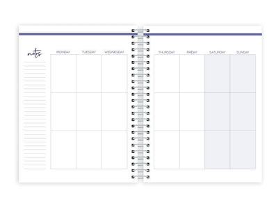 weekly planner featuring weekly spread with silver coil spine, shown on white background.
