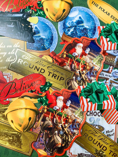 craft kit featuring an assortment of die cuts with scenes and characters from the Polar Express movie, shown overlapping on a green background.