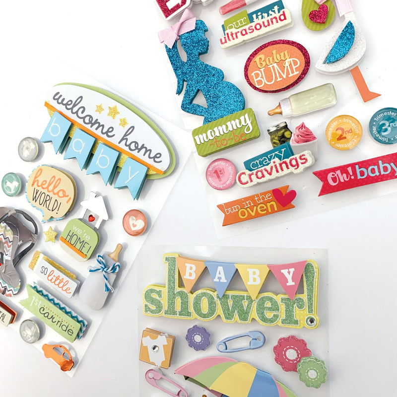 An assortment of scrapbook stickers featuring baby shower, bathtime, we&