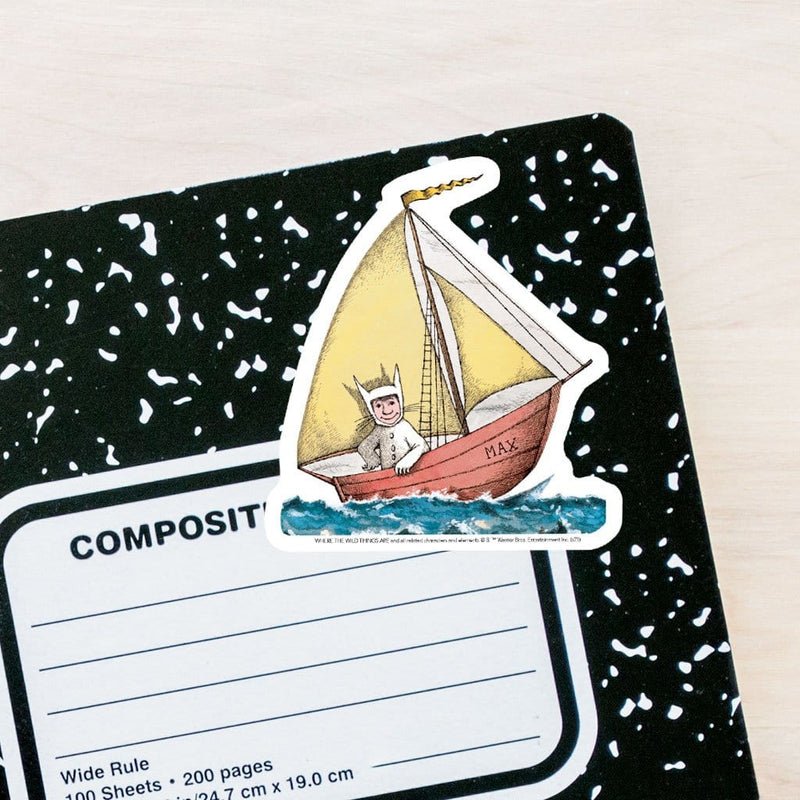 Where the Wild Things Are vinyl laptop sticker featuring a diecut Max in his sailboat adhered to the front of a black and white composition notebook.