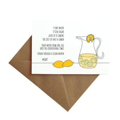 note card featuring an illustrated pitcher with lemons and a written recipe, shown with brown envelope on white background.