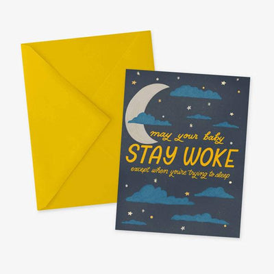 note card featuring an illustrated night sky with "STAY WOKE" text, shown with yellow envelope on a white background.