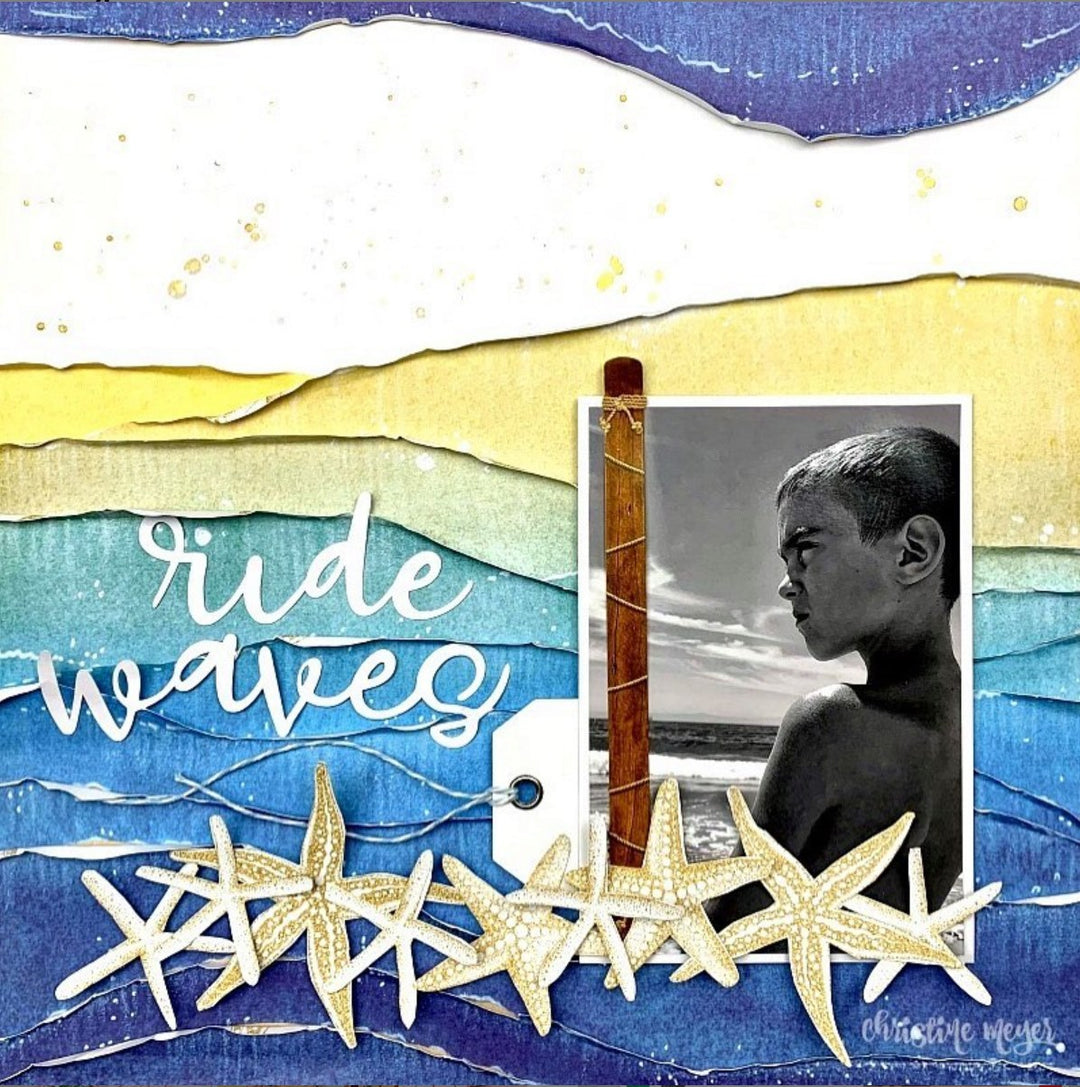 scrapbook page using one photo of a boy at the beach set on a yellow and blue layered background with starfish embellishments