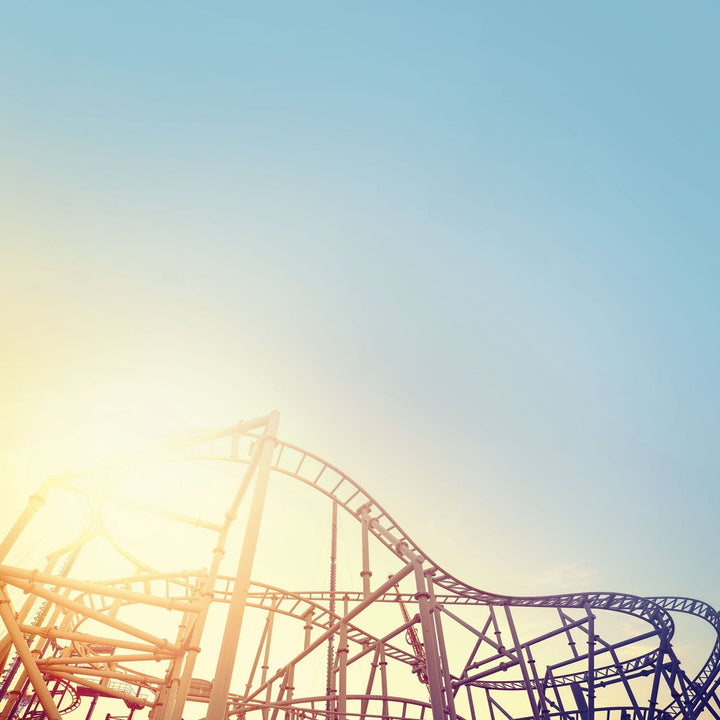 scrapbook paper featuring a light blue sky with a rollercoaster track.