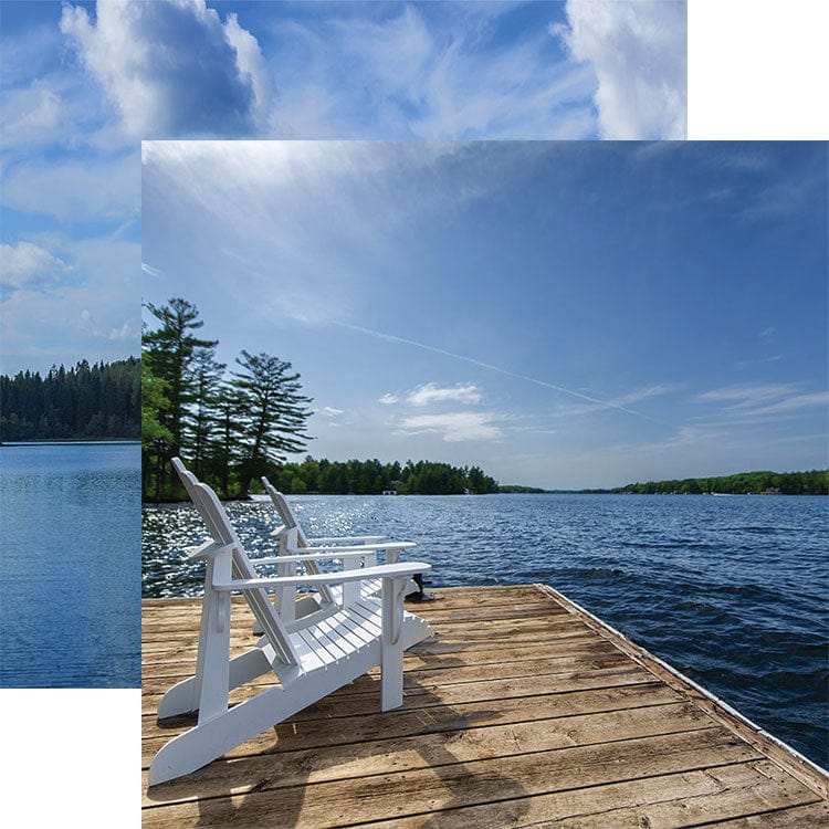 scrapbook paper featuring a photographic image of 2 white chairs on a wooden dock on a lake against a clear blue sky shown overlapping a lake scene.