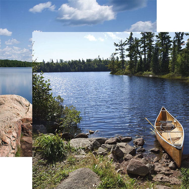 scrapbook paper featuring a photographic image of a canoe resting on a rocky shore at a lake shown overlapping an image of a lake with rocky shore.