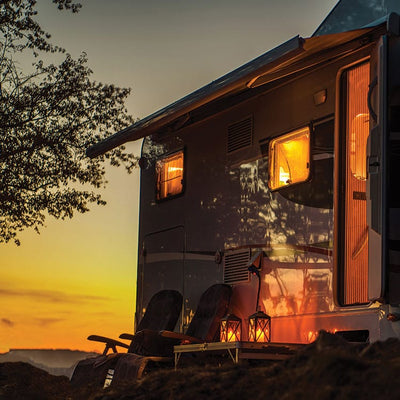 scrapbook paper featuring a close up photographic image of an RV at night against the setting sun.