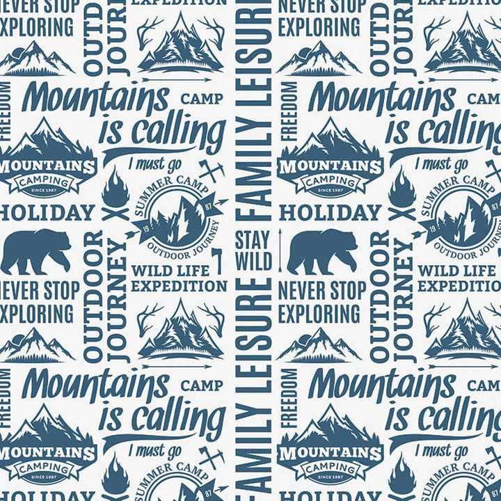 scrapbook paper featuring a pattern of blue words and illustrations of mountains and bears on a white background.