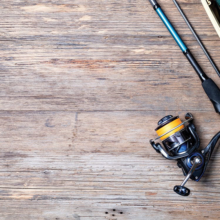 scrapbook paper featuring a close up photographic image of fishing poles on a wood surface.
