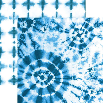 scrapbook paper featuring large circular blue tie-dye pattern on a white background shown overlapping another blue tie-dye pattern.