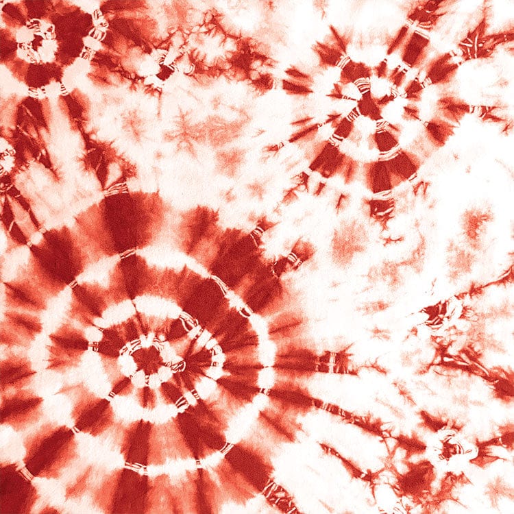 scrapbook paper featuring large circular red tie-dye pattern on a white background.