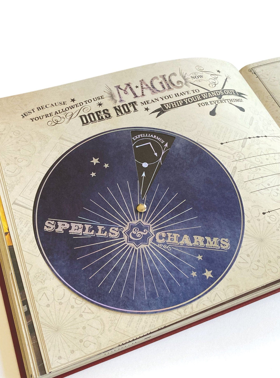 ALB-6000E - Harry Potter Vegan Leather Deluxe Flip Photo and Scrapbook Album - Open album page displaying a blue circular "Spells &amp; Charms" design with radiating lines and stars, topped with a magic quote and wand illustration