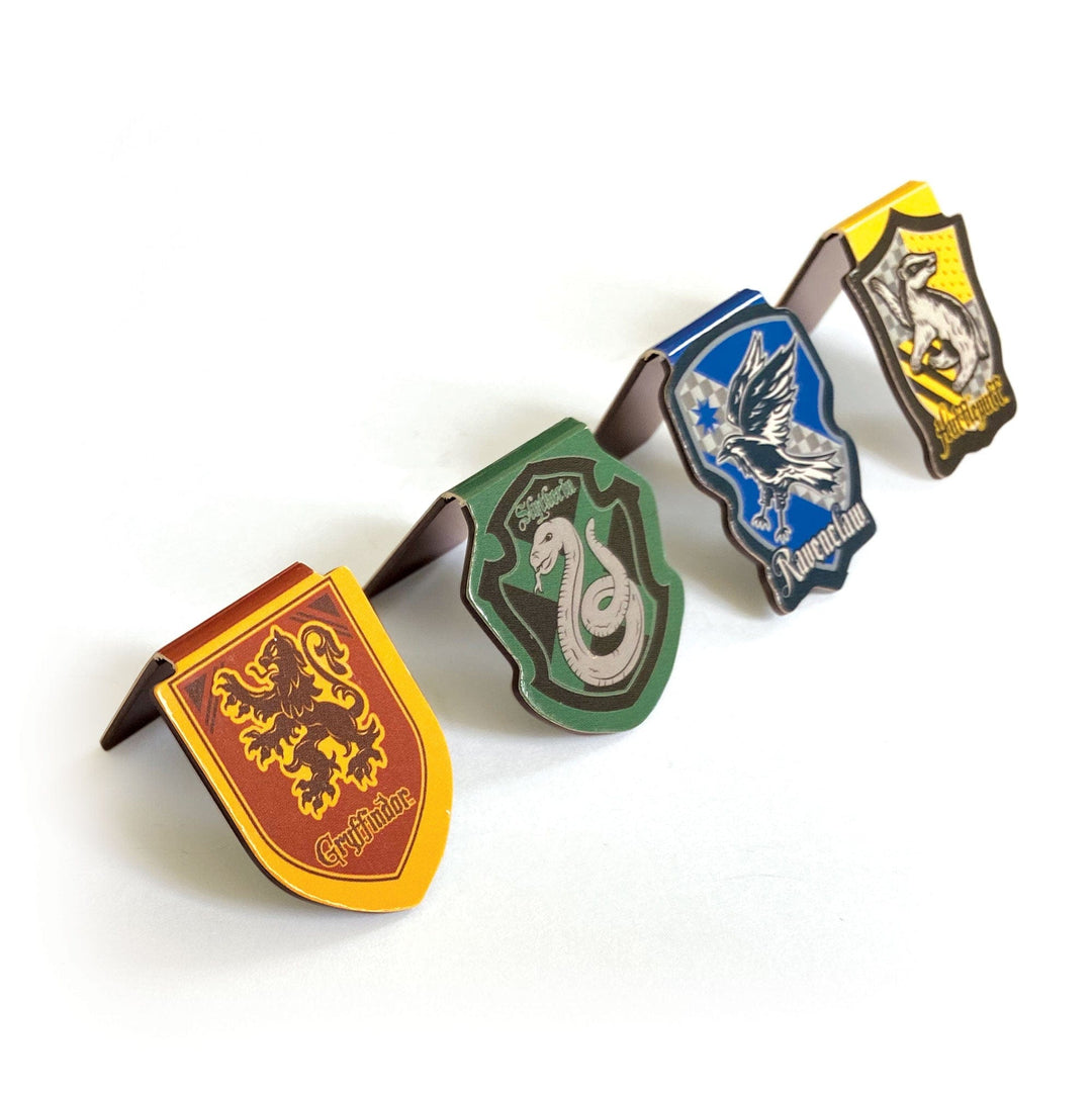 BMMG-0029E - Harry Potter - House Crests Magnetic Bookmarks - Four house crest magnetic bookmarks in red, green, blue, and yellow with brown metal clips arranged in a row