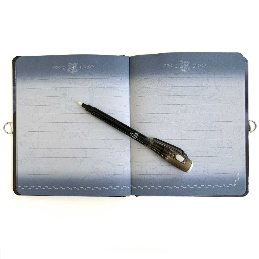 DRY-1000E - Locking Diary - Harry Potter Invisible Ink - Open blue diary with lined pages and a black invisible ink pen resting diagonally across it