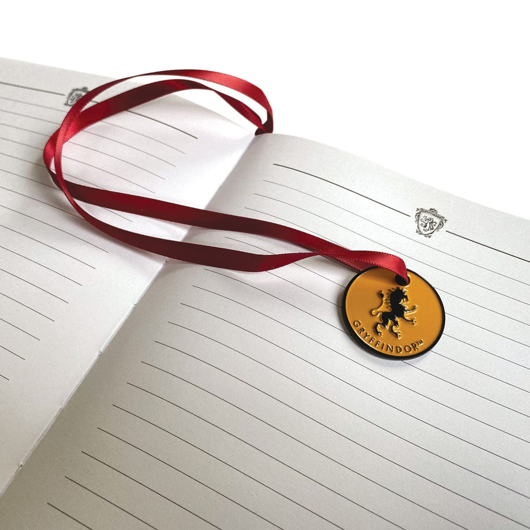 JL-0066E - Harry Potter Gryffindor Vegan Leather Journal - Open lined journal with red ribbon bookmark and gold circular Gryffindor medallion pendant on cover