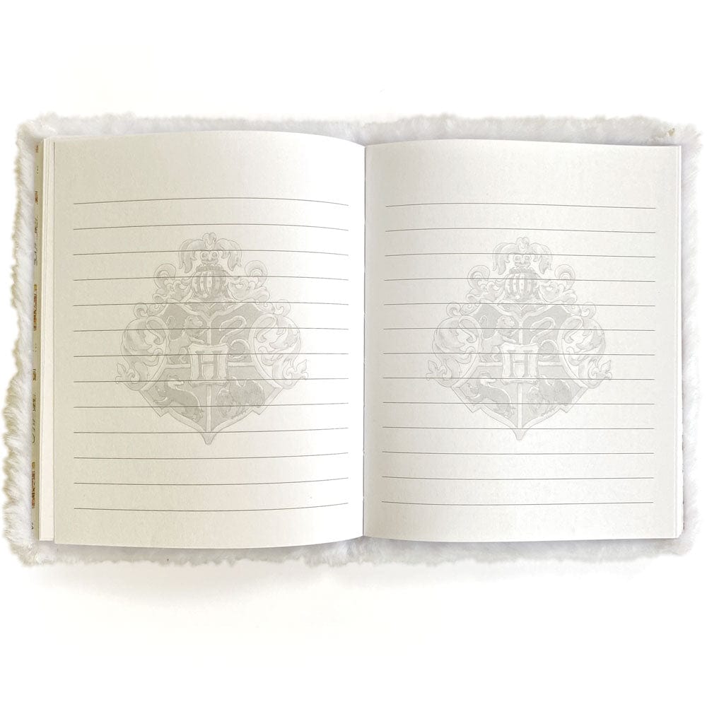 JLP-0002E - Harry Potter Journal Notebook - Plush Hedwig - Open journal with cream-colored lined pages featuring a faint ornate crest watermark, white fuzzy cover visible on sides