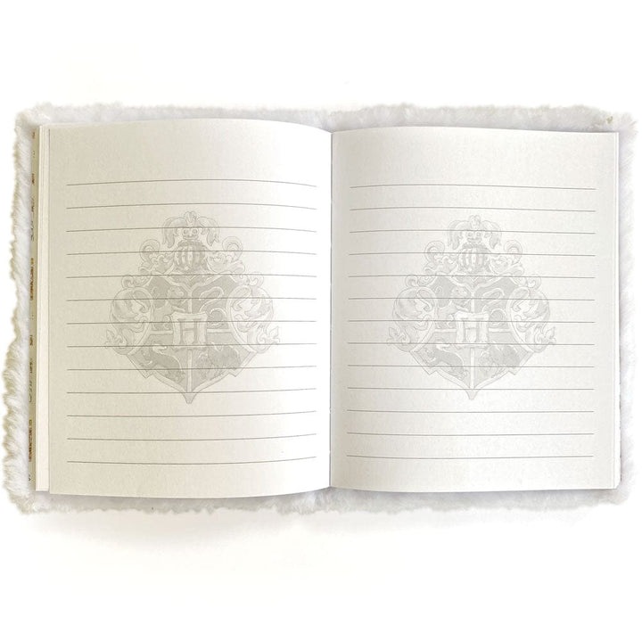 JLP-0002E - Harry Potter Journal Notebook - Plush Hedwig - Open journal with cream-colored lined pages featuring a faint ornate crest watermark, white fuzzy cover visible on sides
