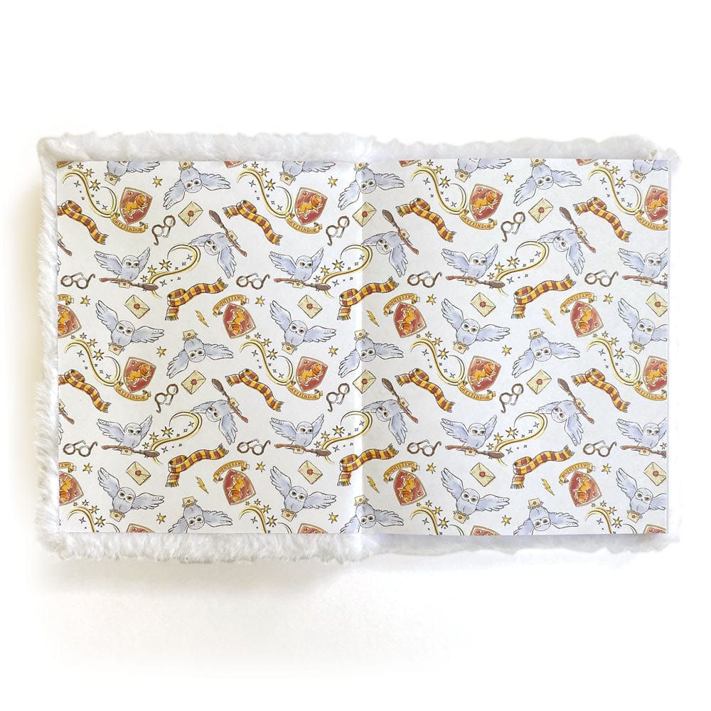 JLP-0002E - Harry Potter Journal Notebook - Plush Hedwig - White plush-bordered notebook with Harry Potter-themed pattern featuring owls, scarves, wands, and magical symbols in gold and burgundy tones