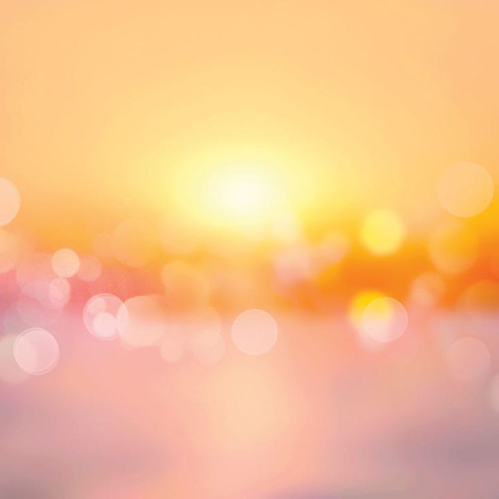 scrapbook paper featuring an orange, pink and yellow bokeh pattern