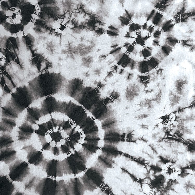 scrapbook paper featuring large circular black tie-dye pattern on a white background.