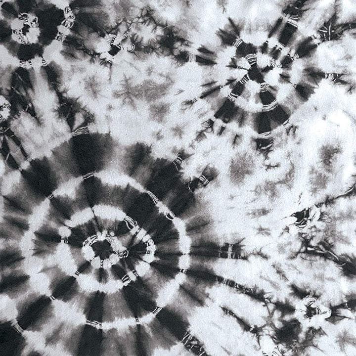 scrapbook paper featuring large circular black tie-dye pattern on a white background.