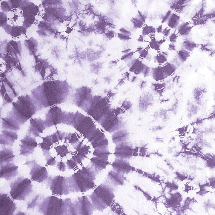 scrapbook paper featuring large circular purple tie-dye pattern on a white background.