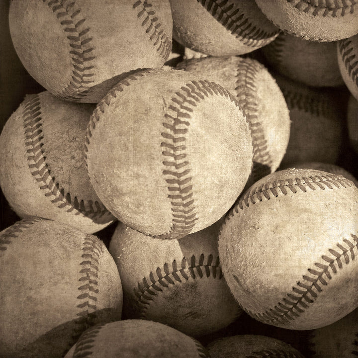 P-2412E - Baseball Tags 12 x 12 Scrapbook Paper - Sepia-toned baseballs with visible red stitching stacked closely together on a neutral background