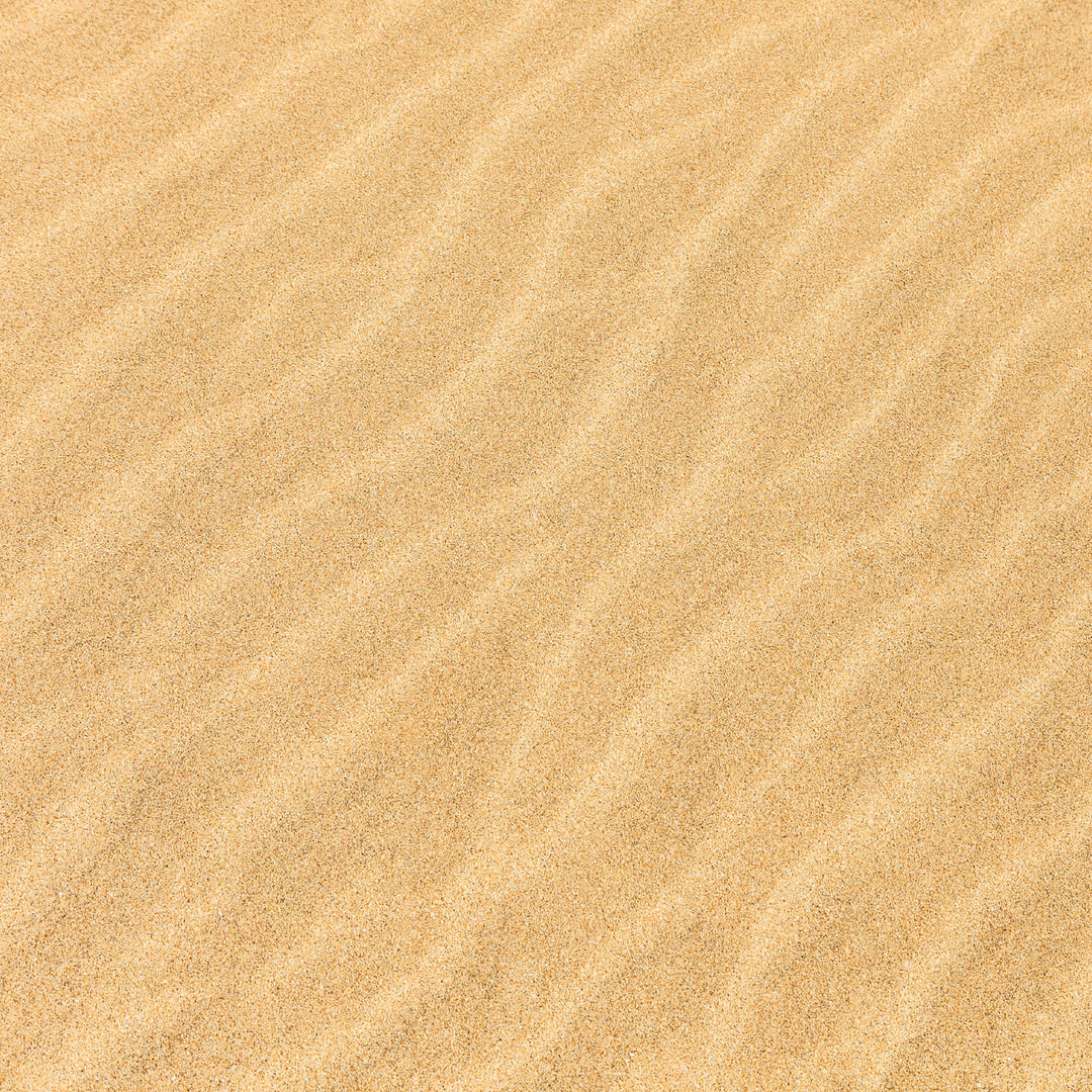 P-2422E - Beach Umbrella 12 x 12 Scrapbook Paper - Sandy beige textured background with diagonal wave patterns throughout