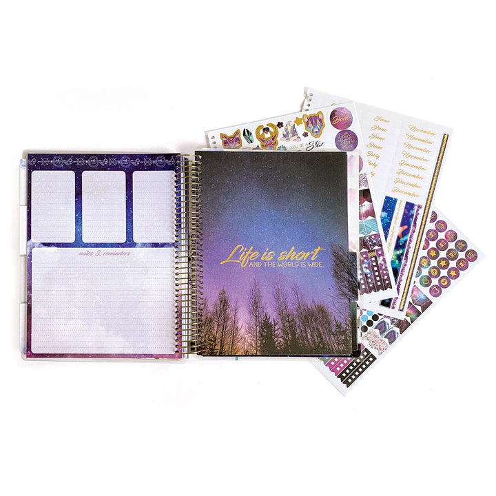 PL-2018E - Weekly Planner - Undated Stargazer - Purple galaxy-themed spiral planner with "Life is short" text, open pages showing notes section, and colorful sticker sheets fanned beside it