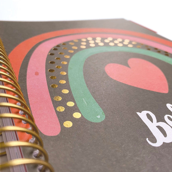 PL-2023E - Weekly Planner - Boho Rainbow - Spiral-bound planner with concentric rainbow stripes, gold foil dots, pink heart, and white text on gray cover