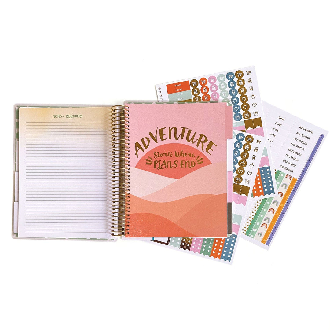 PL-2023E - Weekly Planner - Boho Rainbow - Spiral-bound planner with pink cover featuring "Adventure Starts Where Plans End" text, displayed with coordinating sticker sheets and decorative washi tape strips