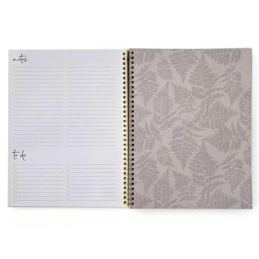PL-2036E - Books &amp; Flowers 12 Month Undated Planner - Open spiral-bound planner showing notes and to-do list pages on left, fern-patterned cover on right with gold binding