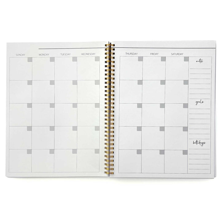 PL-2040E - Through the Keyhole 12 Month Undated Planner - Open spiral-bound weekly planner with gold binding, cream pages, and sections for notes, goals, and birthdays