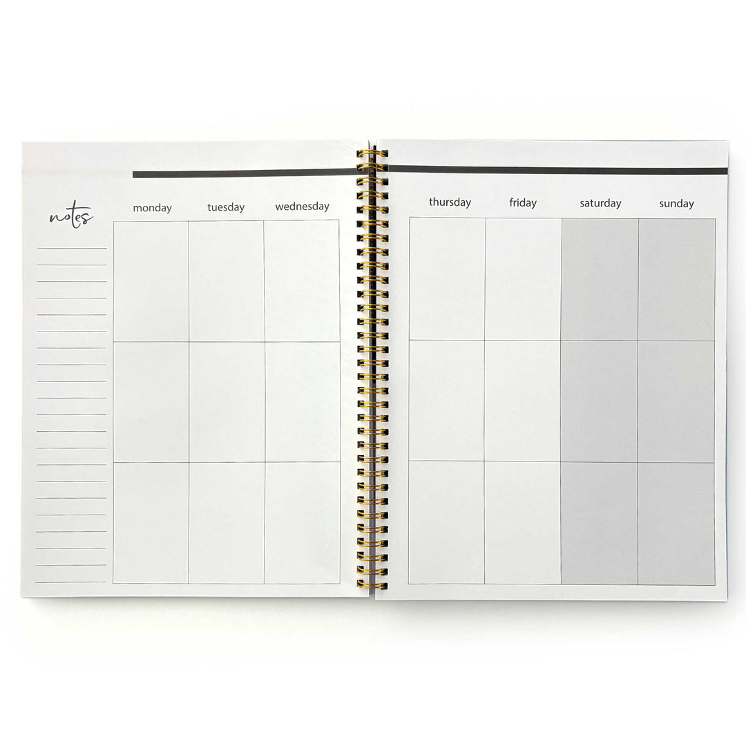 PL-2040E - Through the Keyhole 12 Month Undated Planner - Open spiral-bound planner showing weekly layout with Monday-Sunday columns, notes section, and gold binding