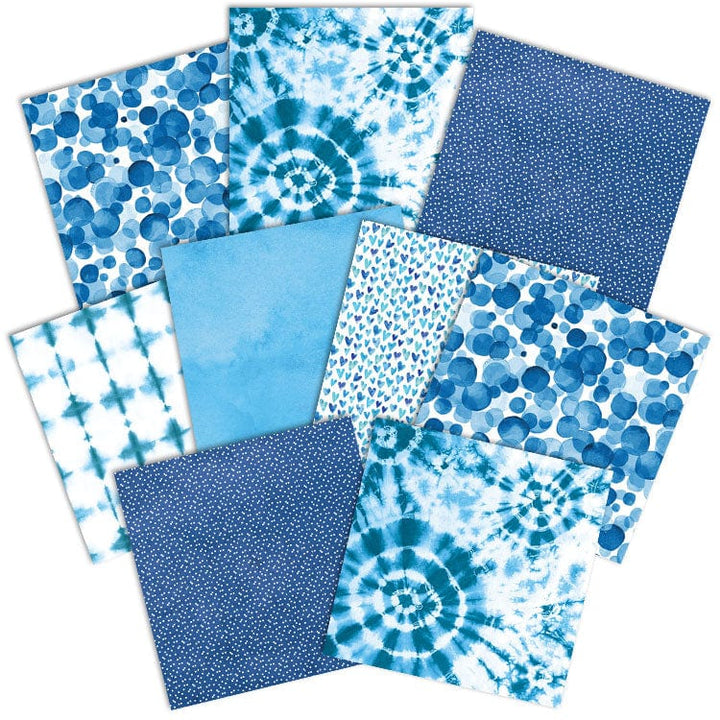 PSET-0019E - Blue Colorways Pattern 12 x 12 Scrapbook Paper Set - Nine blue-toned patterned sheets featuring tie-dye, polka dots, hearts, and geometric designs arranged in a fan layout