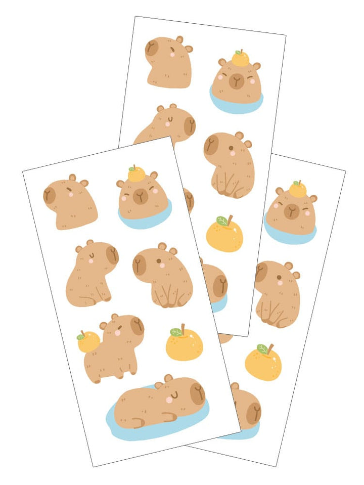 ST-2440E - Decorative Stickers - Capybara - Three sheets of tan capybara stickers with yellow apples and blue water accents on white backgrounds