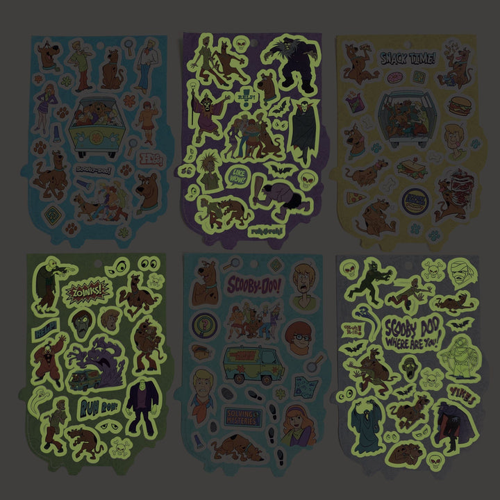 STBK-3000E - Scooby Doo Mystery Machine Sticker Book - Six colorful sticker sheets featuring Scooby-Doo characters, mystery themes, and glow-in-the-dark elements on blue, purple, yellow, and green backgrounds