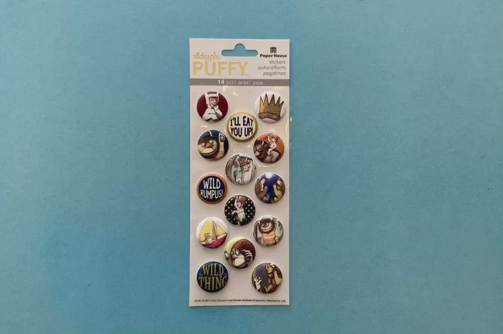 female hands display puffy stickers featuring Where the Wild Things Are characters and scenes, shown in circles, and shows a close up of one of the individual stickers.