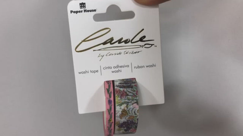 Hands pick up washi tape set in package and shows the 2 tapes featuring hand painted florals by Carole Shiber.