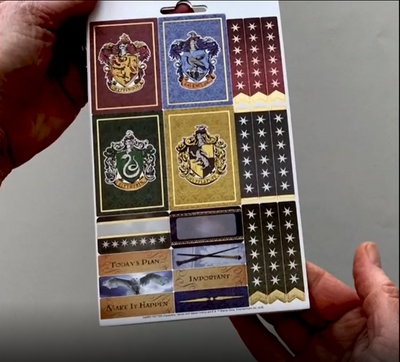 Female hands pick up and flip through the pages of the "Harry Potter" planner stickers booklet to show each page of stickers in detail. There are four pages in this sticker book by Paper House Productions.