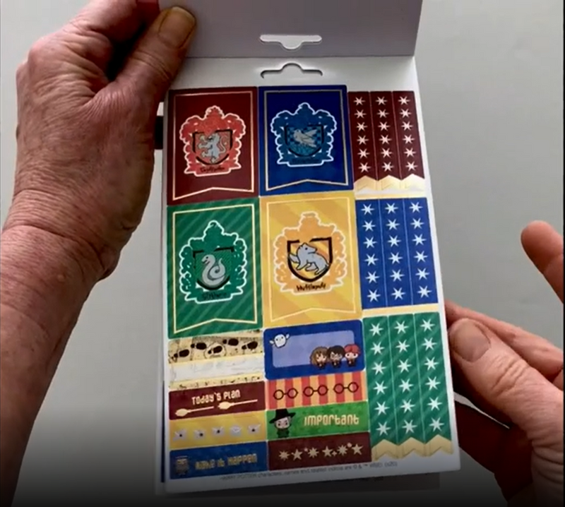Female hands pick up and flip through the pages of the "Harry Potter-Chibi" planner stickers booklet to show each page of stickers in detail. There are four pages in this sticker book by Paper House Productions.