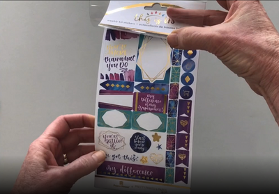 Female hands pick up and flip through the pages of the "Empowerment" planner stickers booklet to show each page of stickers in detail. There are four pages in this sticker book by Paper House Productions.