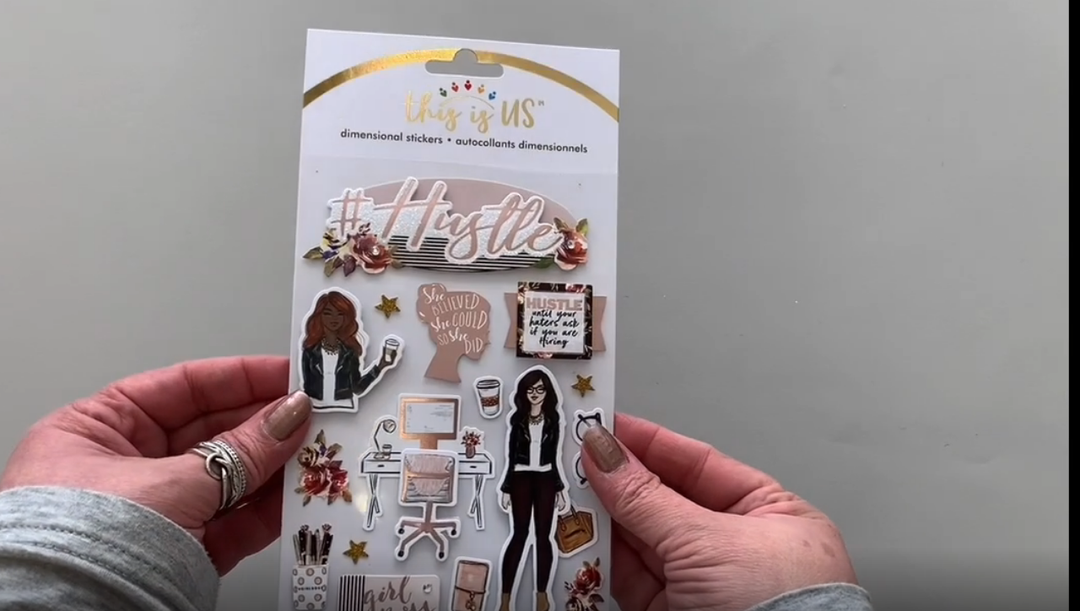 Female hands pick up and show front and back of 3D scrapbook stickers featuring girl boss with illustrations of sunglasses and florals.